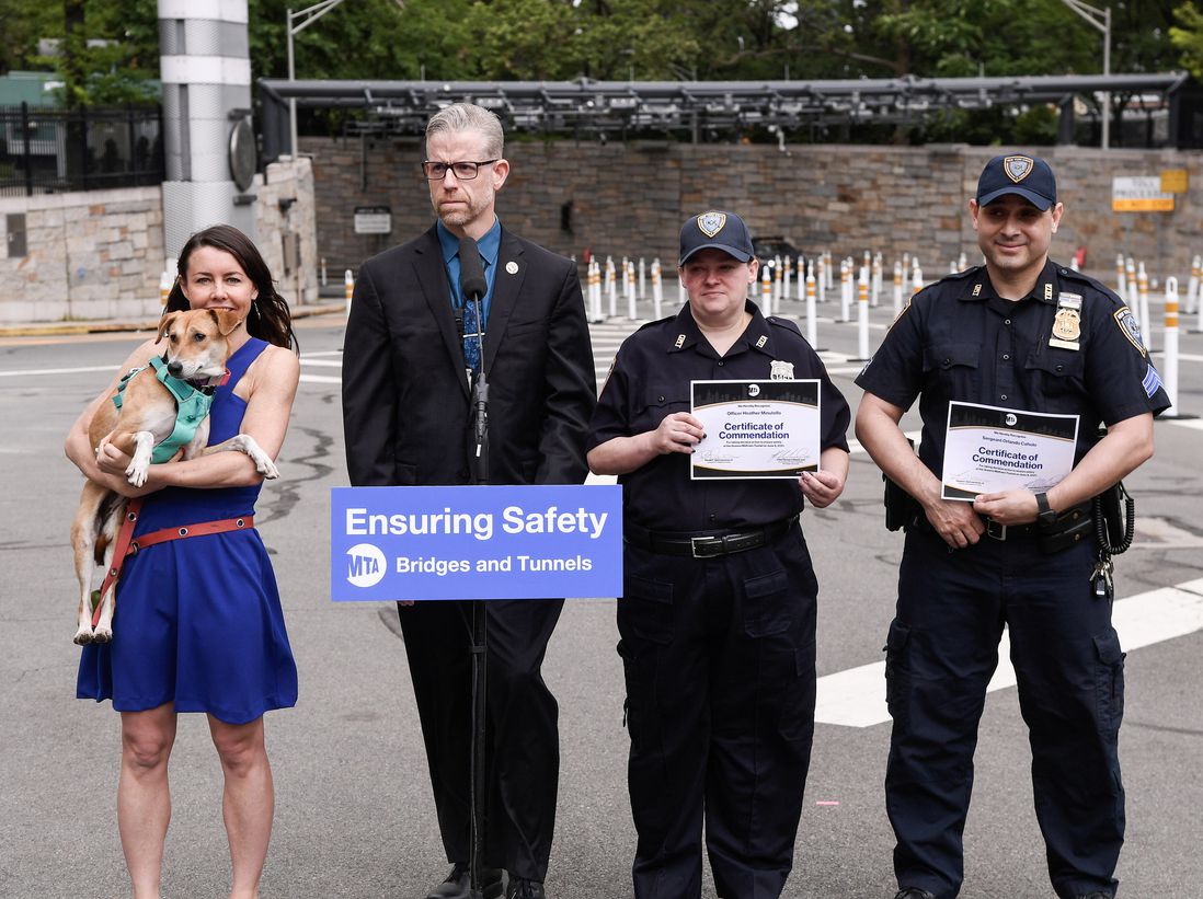 Photos of MTA Bridges & Tunnels Vice President and Chief of Operations Richard Hildebrand presenting commendations to Sgt. Orlando Caholo and BTO Heather Minutello at the Queens Midtown Tunnel after rescuing the lost dog Indie
